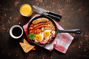 Full English breakfast served in a frying pan.