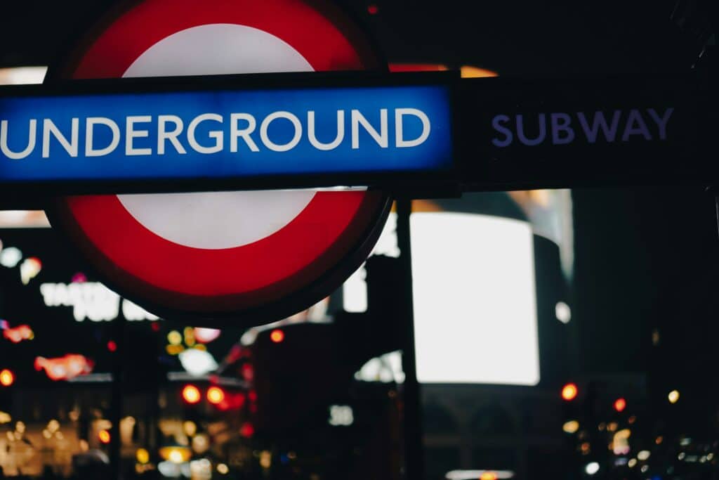 London Underground sign at night.